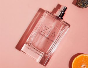 Perfume bottle with orange slices and rock