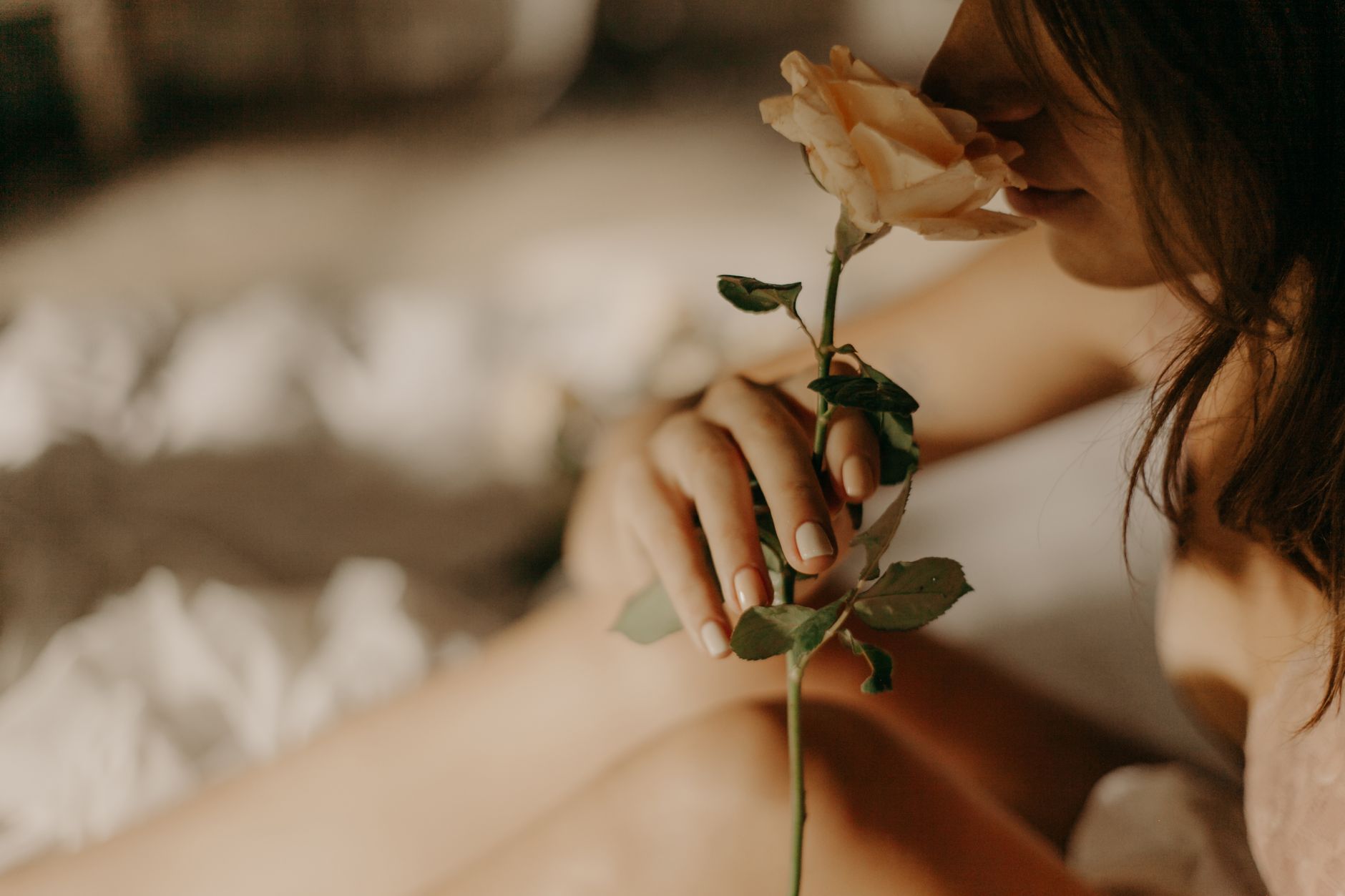 Femme respirant le parfum d’une rose
